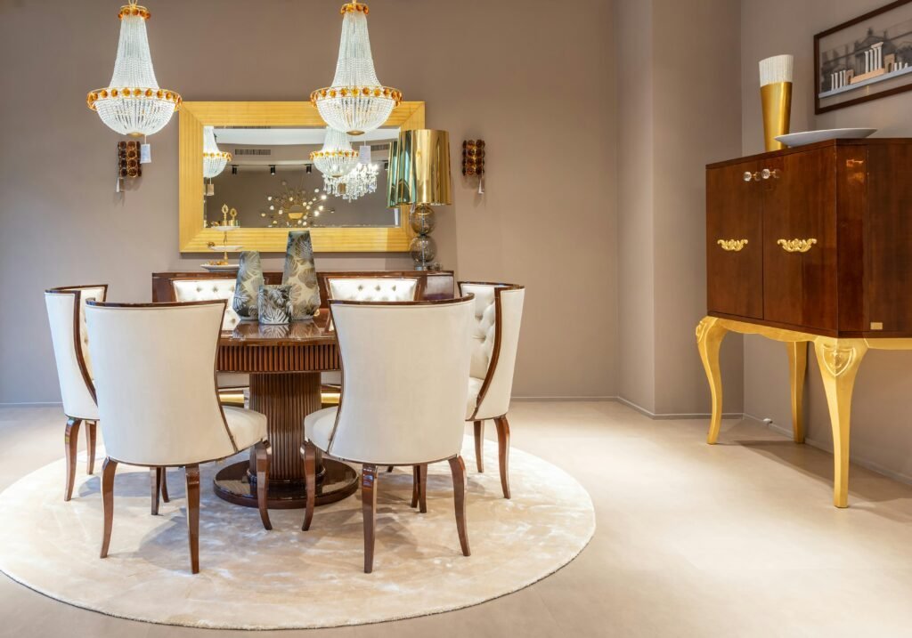 pexels-photo-7535046-7535046 Chairs at round wooden table with decorative vases on placed on rug near wall with mirror in spacious apartment with cabinet